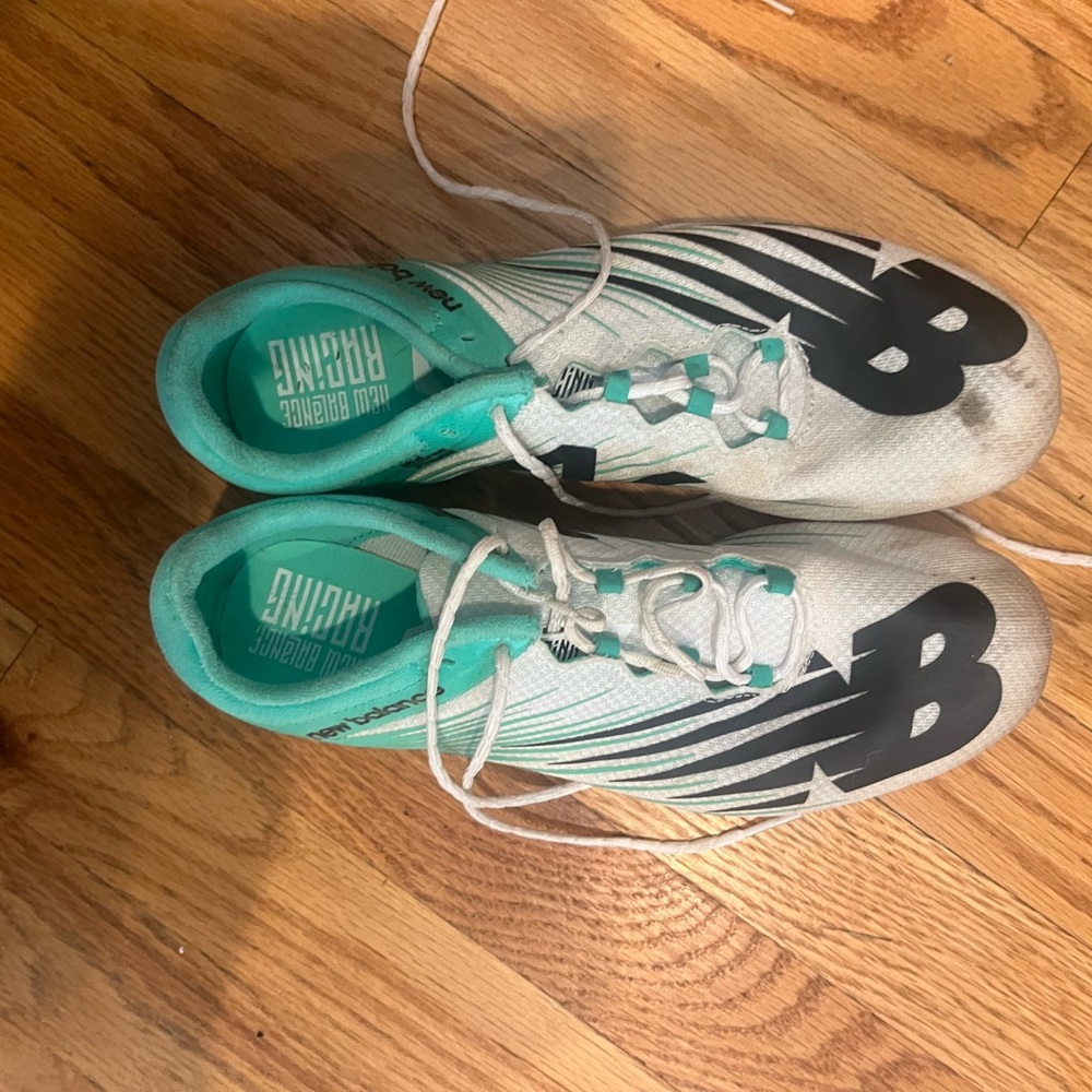 Teal and white new balance track spikes